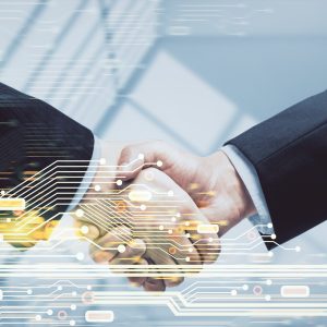 Double exposure of data theme hologram and handshake of two men. Partnership in IT industry concept.